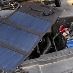 Flexible solar panel kit installed on a car engine bay for vehicle power, emergency use, and off-grid energy solutions. Ideal for outdoor travel, RVs, and solar vehicle systems.