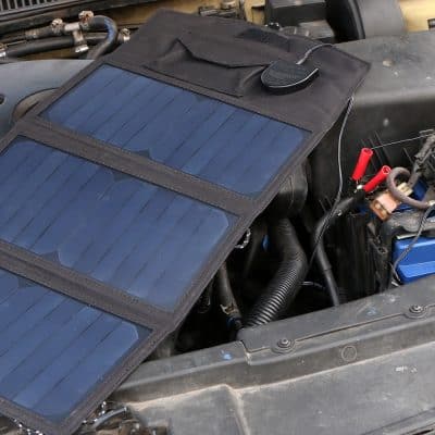 Flexible solar panel kit installed on a car engine bay for vehicle power, emergency use, and off-grid energy solutions. Ideal for outdoor travel, RVs, and solar vehicle systems.