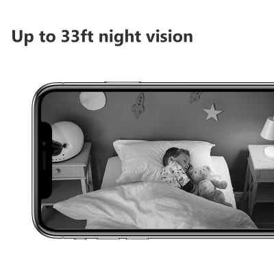 Child sleeping peacefully in bed with teddy bear, up to 33ft night vision, image framed by smartphone, promoting optometry and vision health.