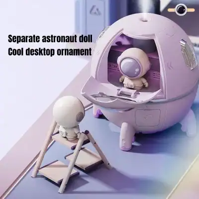 A cute astronaut doll figurine with a space helmet, shown sitting inside a spherical desktop ornament resembling a spacecraft, perfect as a modern desk decor piece.
