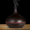 Essential oil diffuser with warm wood grain finish, remote control, and adjustable timing settings, enhances home ambiance and air quality. Ideal for relaxation and wellness routines.