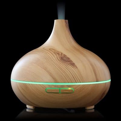 Aromatherapy essential oil diffuser with a wood grain finish, ultrasonic mist, and adjustable light settings, perfect for home or spa relaxation.