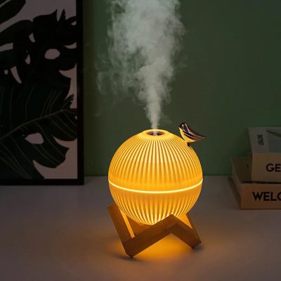 Air aroma diffuser with mist vapor, modern design for wellness and relaxation in home or spa settings.