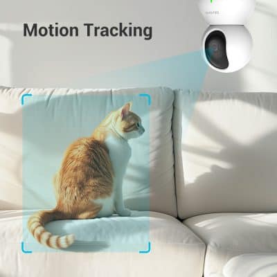 Motion tracking security camera monitoring a sitting cat on a white sofa, highlighting smart pet surveillance and home security from Monalisa Store.