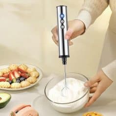 Handheld electric whisk for kitchen use, stainless steel design, easy to operate, ideal for whipping cream, eggs, and desserts, perfect for home baking and cooking enthusiasts.