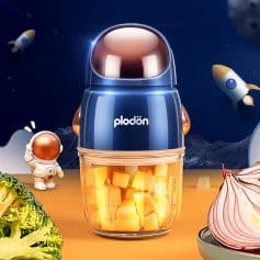 Smoothie maker with diced fruits, space-themed background with rockets and astronaut figure, ideal for healthy living and kitchen gadgets at Monalisa Store.