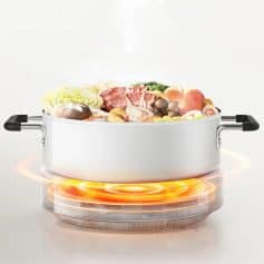 Sleek electric hot pot with, fresh ingredients for hotpot cooking, modern cookware for healthy meals.