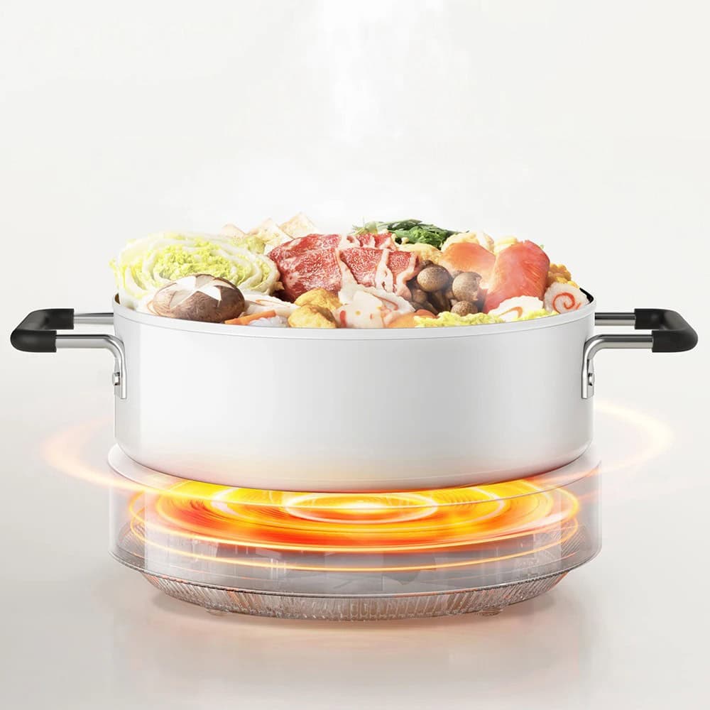 Sleek electric hot pot with, fresh ingredients for hotpot cooking, modern cookware for healthy meals.