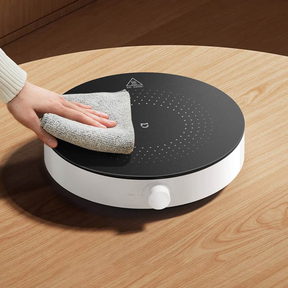 Modern portable induction cooktop with digital controls, sleek black surface, perfect for efficient cooking at home or small kitchens.