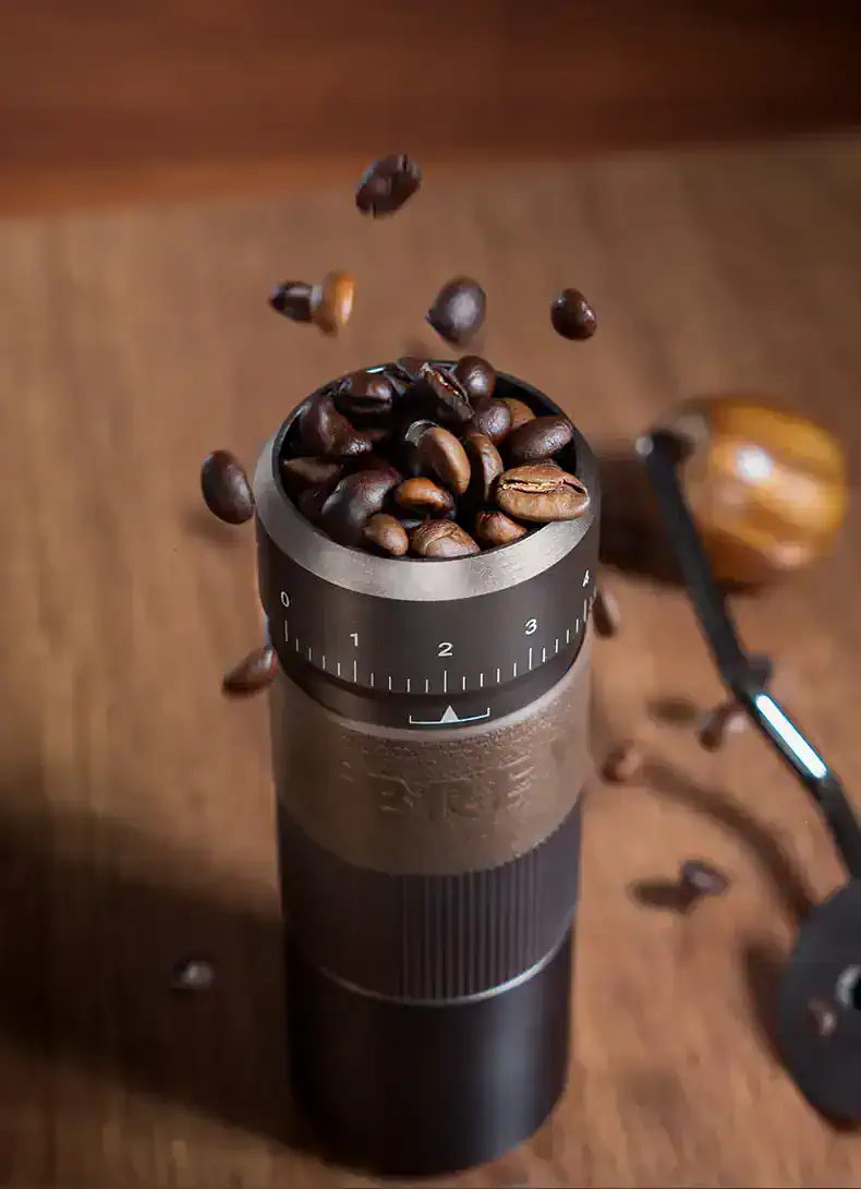 Fresh roasted coffee beans being ground in a coffee grinder, showcasing premium coffee preparation for café or home brewing.
