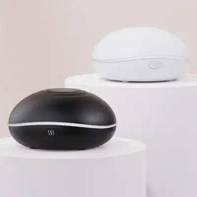 Air purification device for home and office, sleek modern humidifier, Monalisa Medical, stylish black and white air purifier for optimal indoor air quality, compact and quiet design.