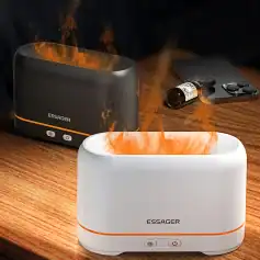 Ultrasonic essential oil diffuser producing mist and heat, black and white models, for therapeutic aromatherapy, home spa, and relaxation, on wooden surface.