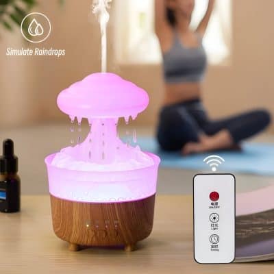 Aromatherapy diffuser emitting mist with soft purple light, set on a wooden surface with a woman practicing yoga in the background, promoting relaxation and wellness.