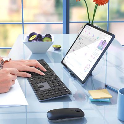 Fresh fruit on a blue desk, modern tablet with health app, and decorative flowers create a vibrant, health-focused workspace for optimal wellness and beauty at Monalisa Store.
