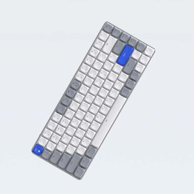 White and gray compact mechanical keyboard with blue Escape and Enter keys, ergonomic design, ideal for office and gaming setups.