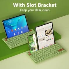 Keyboard with slot bracket keeping desk organized for electronic devices and smartphones, modern desk accessory for workspace organization.
