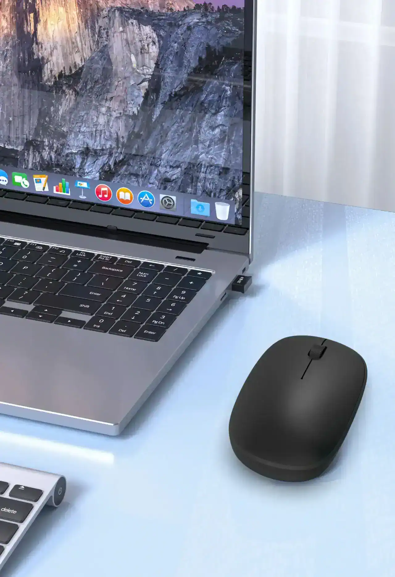 Laptop with macOS display, wireless mouse, and office supplies at Monalisa Store for optical and eyewear shopping.