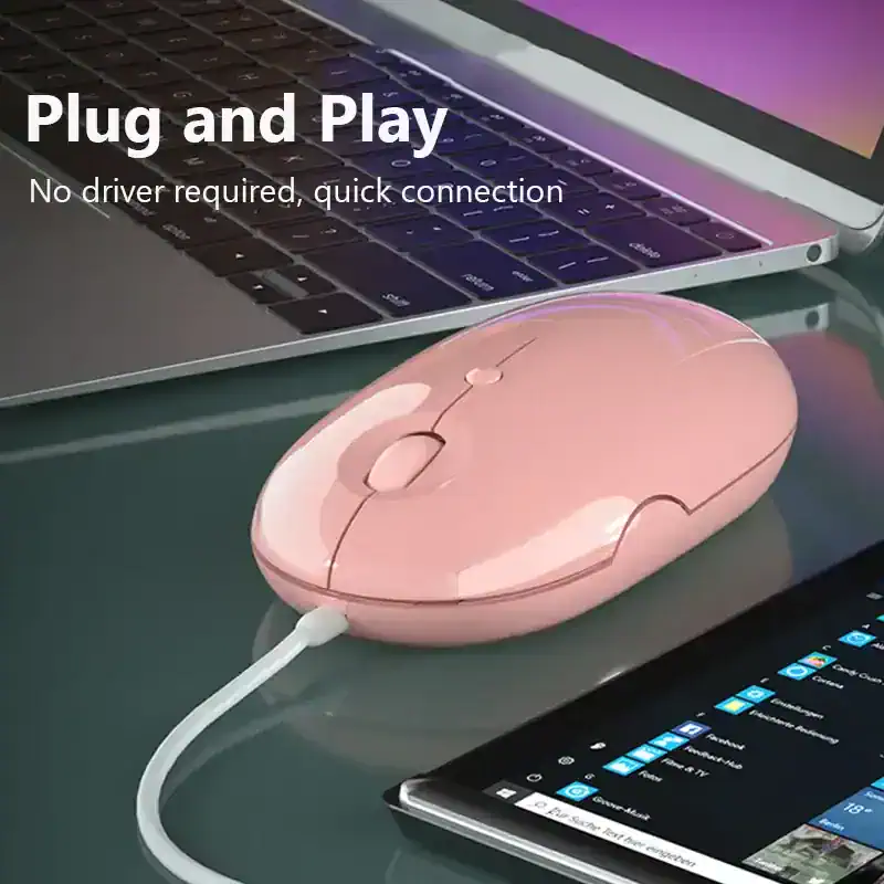 Pink wireless computer mouse on laptop and tablet with folder icons and apps - close-up of wireless mouse for computer and laptop use.