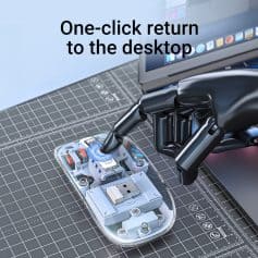 Flexible black robotic hand interacting with a computer mouse on a grid cutting mat, illustrating automation and technology.