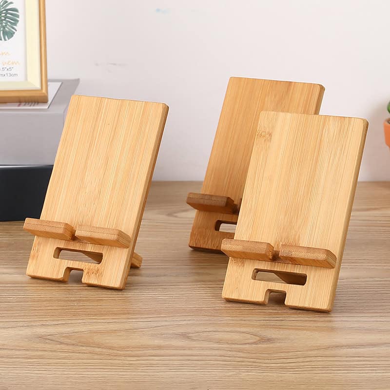 Natural bamboo phone stand for comfortable, hands-free viewing, stylishly designed for office or home use. Eco-friendly material enhances visual appeal and durability.