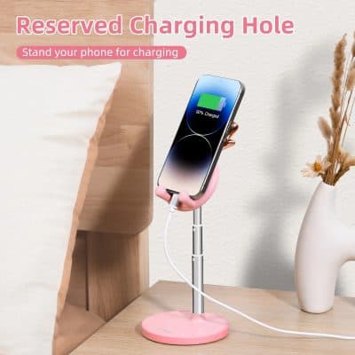 Wireless charging stand for smartphones with a reserved charging hole, pink color, ideal for bedside or desk use.