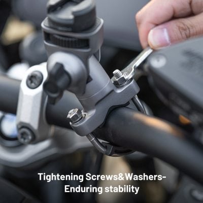 Bolt tightening process on motorcycle handlebar stem for bike maintenance and stability, close-up shot of wrench tightening screws and washers, emphasizing durable components and secure assembly for optimal riding performance.