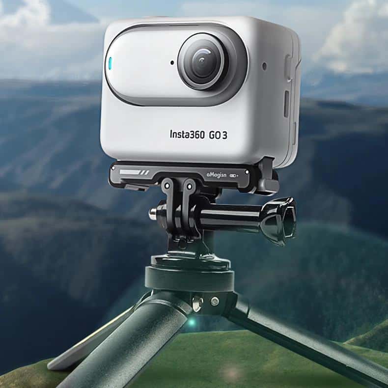 Insta360 GO 3 action camera mounted on tripod with scenic mountain landscape background.