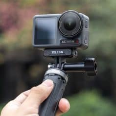 Action camera mounted on a handheld stabilizer for outdoor filming, showcasing advanced video and photo capture technology for high-quality content creation.