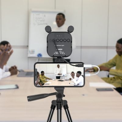 Advanced recording setup with microphone and smartphone, capturing a professional presentation in a modern office or classroom environment.