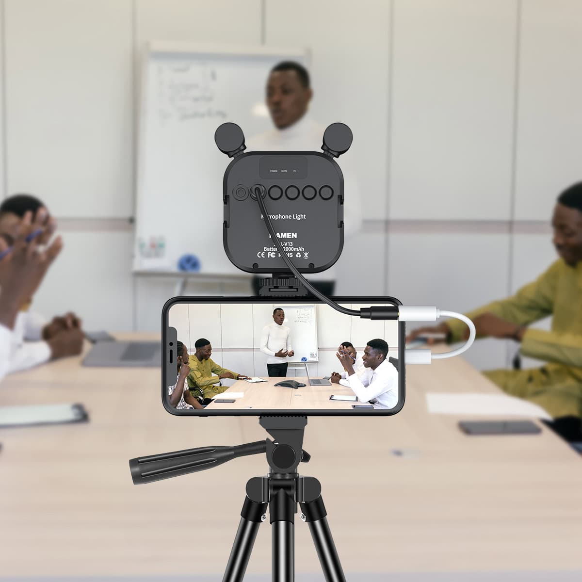 Advanced recording setup with microphone and smartphone, capturing a professional presentation in a modern office or classroom environment.