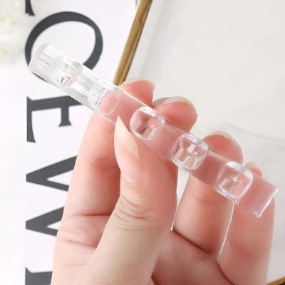 Sleek transparent glass nail art sample holder with square-cut nails, ideal for beauty salon and manicure displays, showcasing precision and style for nail design presentation.