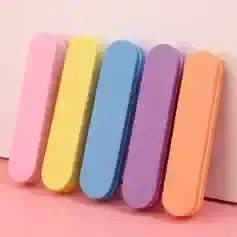 Bright pastel-colored nail buffers in pink, yellow, blue, purple, and orange for professional manicures and skincare routines.