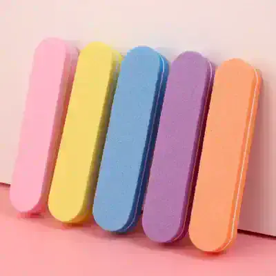 Bright pastel-colored nail buffers in pink, yellow, blue, purple, and orange for professional manicures and skincare routines.