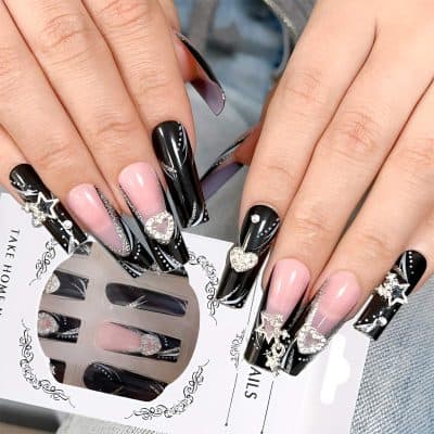 Elegant black and pink acrylic nail art with metallic accents, rhinestones, and 3D heart charms, showcasing luxury nail design at Monalisa Store.