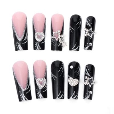 Elegant black and pink acrylic nails with sparkling silver glitter accents and 3D rhinestone charms, perfect for trendy nail art and fashion-forward looks.