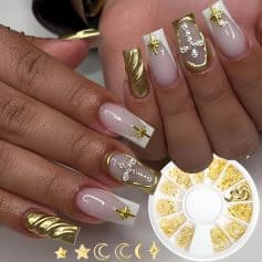 Elegant gold and white manicure with intricate nail art, 3D gold star embellishments, and decorative rhinestones showcasing advanced nail design techniques at Monalisa Store.