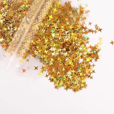 Shimmery gold star-shaped nail glitter for eye-catching nail art designs, available at Monalisa Store for professional and DIY beauty enhancement projects.