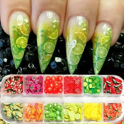 Colorful lemon-themed nail art with fruit slice designs, perfect for summer or tropical looks, showcasing Monalisa Medical's nail art services and supplies.