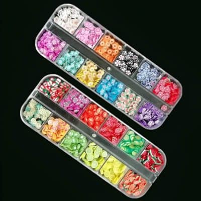 Colorful nail art rhinestones and embellishments organized in clear plastic containers for manicure and pedicure designs.
