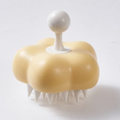 White and beige scalp massage brush with gentle silicone bristles for relaxation and scalp health, ideal for daily hair care routines. Perfect for stimulating blood circulation and promoting healthy hair growth.