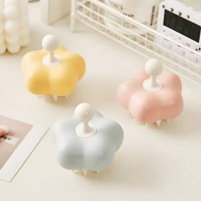 Yellow, pink, and white cloud-shaped storage containers with round handles, set on a white desk with office accessories. Ideal for organizing supplies in a stylish, colorful manner.