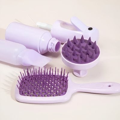 Folding hairbrush and scalp massager designed for hair care and styling, in light purple color.