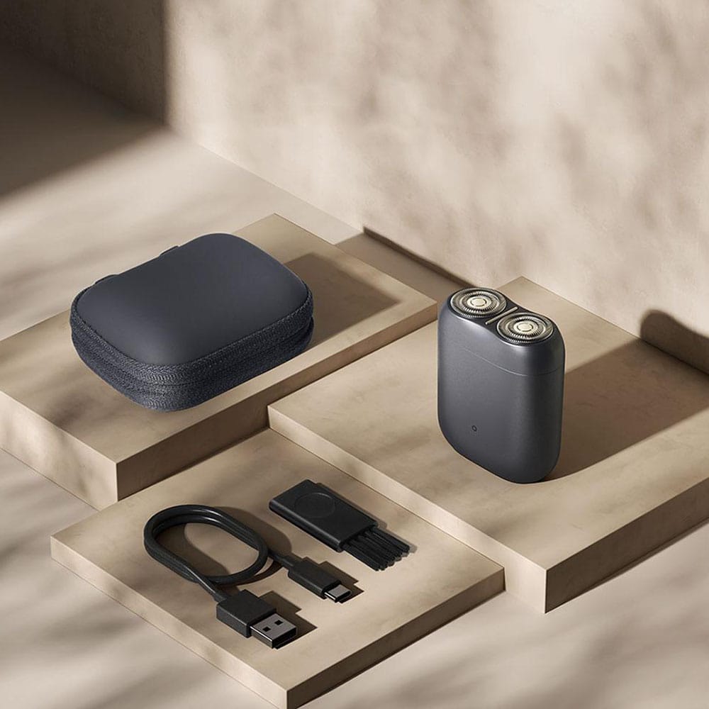 Premium electric shaver with dual rotary blades, portable design, rechargeable battery, included cleaning brush, and carrying case for men's grooming. Perfect for stylish and comfortable shave.