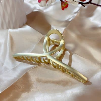 Gold hair clip with pearl accents on soft satin fabric, elegant hair accessory, perfect for hair styling, women’s fashion, beauty accessories, Monalisa Store.