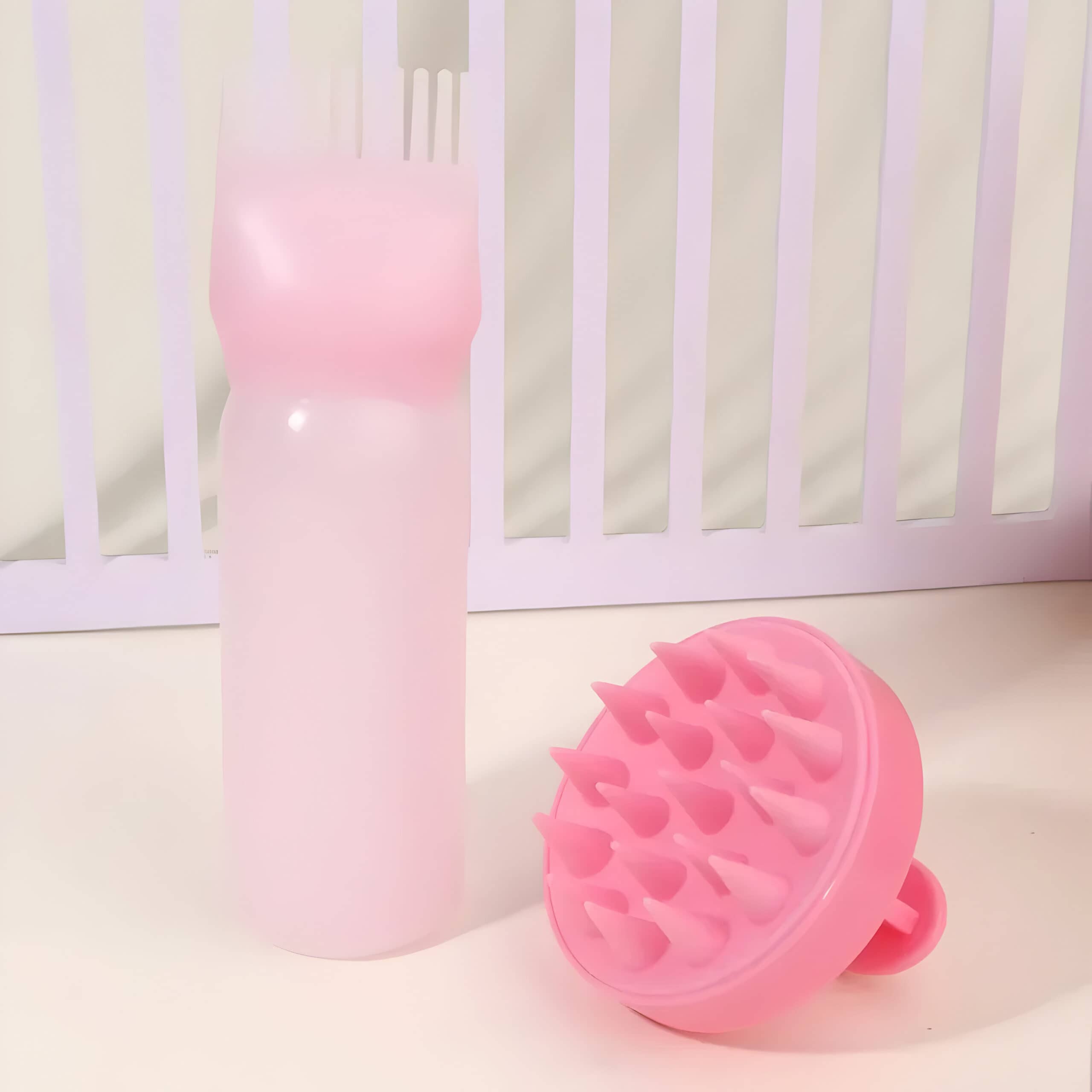 Pink silicone scalp massager and spray bottle, beauty and skincare tools for scalp health and hygiene, ideal for haircare routines, gentle on skin, stylish design.