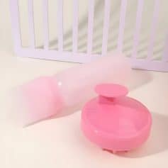 Pink contact lens case with a clear plastic protective cover on a white background at Monalisa Medical Store.