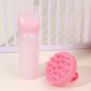 Pink baby bottle and silicone teething toy for infants, ideal for pediatric dental health and soothing young children. Perfect for newborns and toddlers.