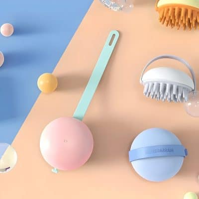 Flexible silicone facial cleansing brush in pastel colors for gentle skincare routines.