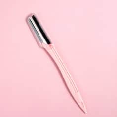 Stylish pink and silver eyebrow razor for precise grooming and shaping, perfect for facial hair removal and skincare routines.