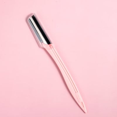 Stylish pink and silver eyebrow razor for precise grooming and shaping, perfect for facial hair removal and skincare routines.